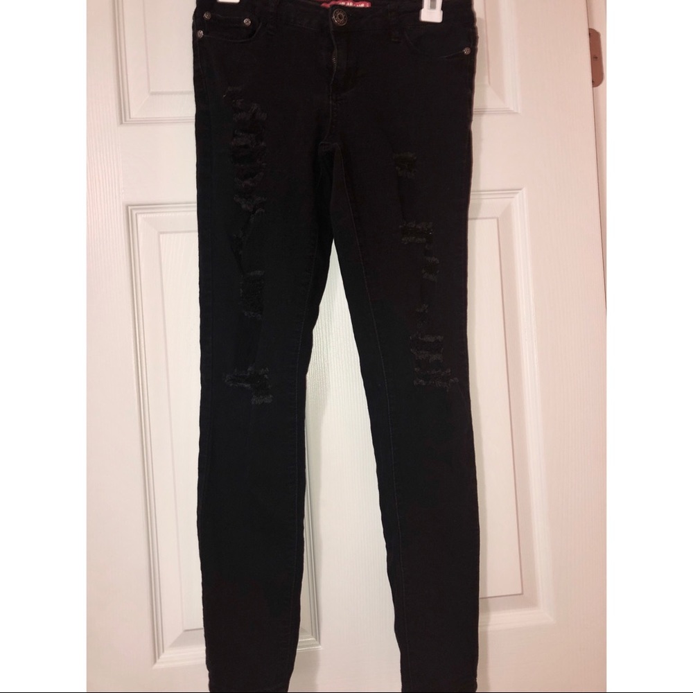 Distressed black skinny jeans